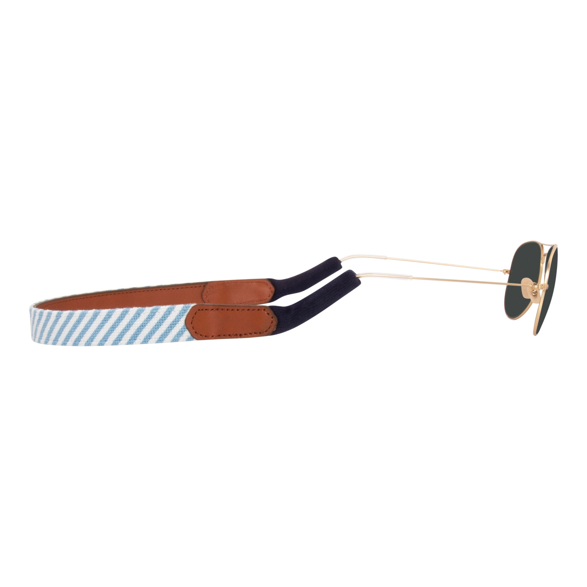 Side view seersucker needlepoint sunglass strap showing a blue and white seersucker classic pattern with sturdy cotton covered silicone ear connectors and a soft leather backing