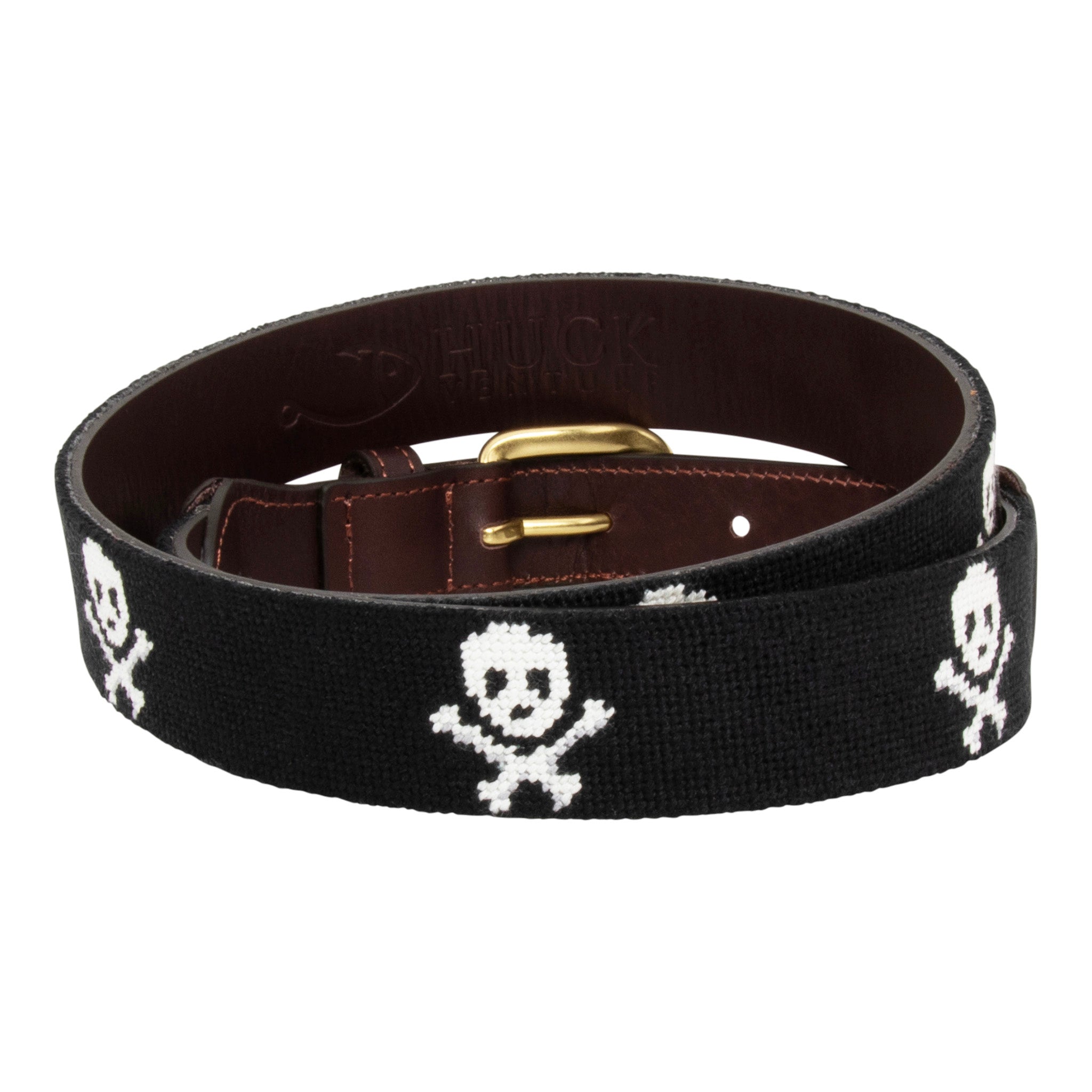 Jolly Roger Needlepoint Belt with black background showing a repeating pattern of evenly spaced white skull and crossbones pattern. Belt has a brass buckle and full grain leather backing and strap.