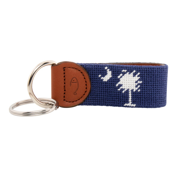 needlepoint keychain showing South Carolina State Flag against navy blue background, Palmetto and crescent, same design on both sides hand-stitched, leather backing with stainless steel keyring