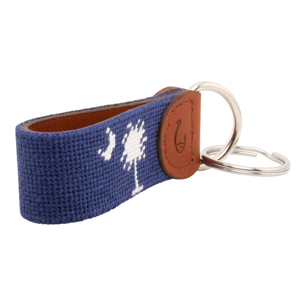 needlepoint keychain showing South Carolina State Flag against navy blue background, Palmetto and crescent, same design on both sides hand-stitched, leather backing with stainless steel keyring