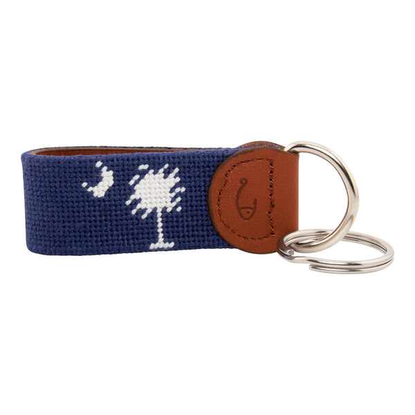 needlepoint keychain showing South Carolina State Flag against navy blue background, Palmetto and crescent, same design on both sides hand-stitched, leather backing with stainless steel keyring